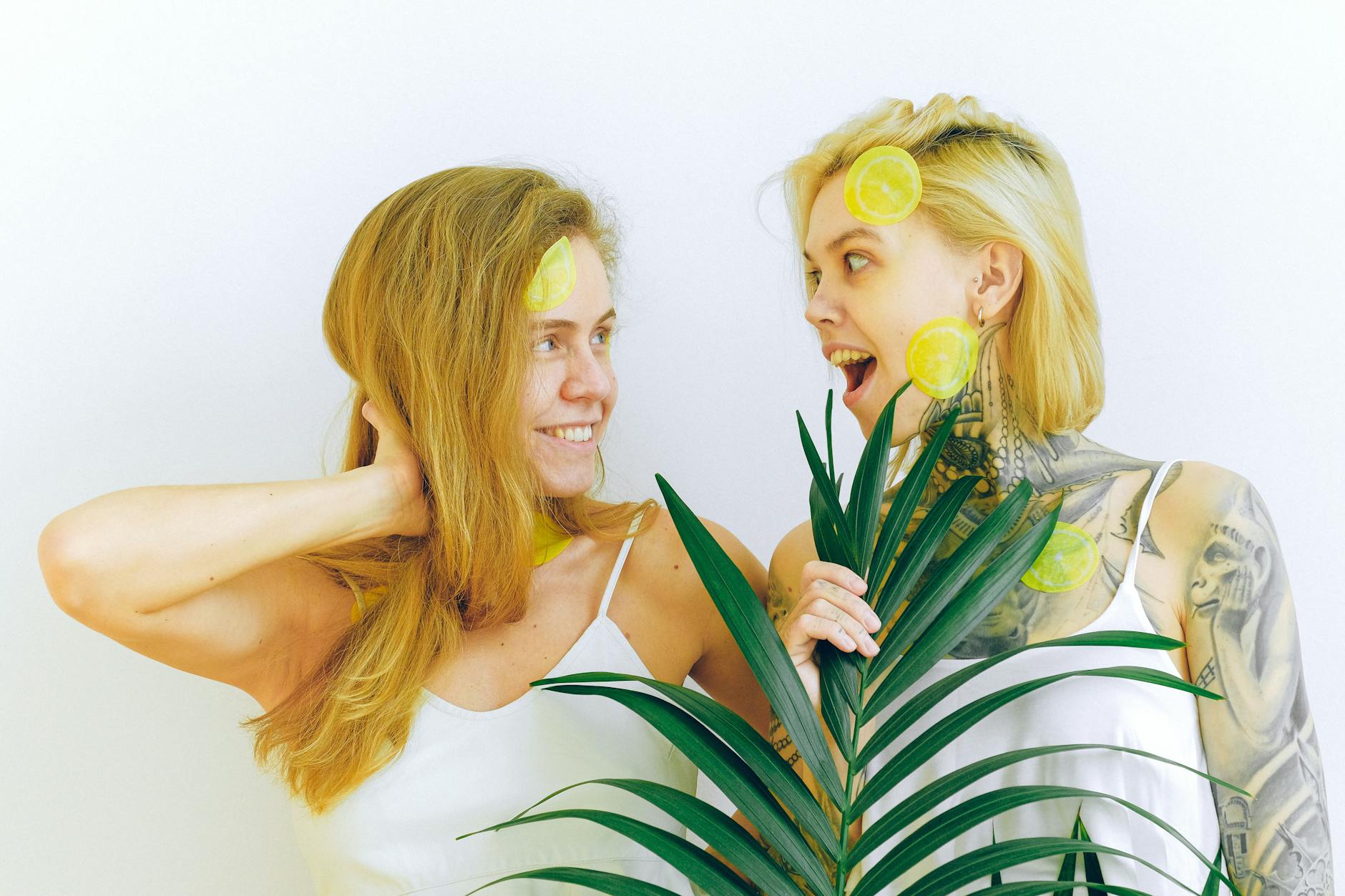 Two people smiling together with tropical plants, expressing joy and intimate connection