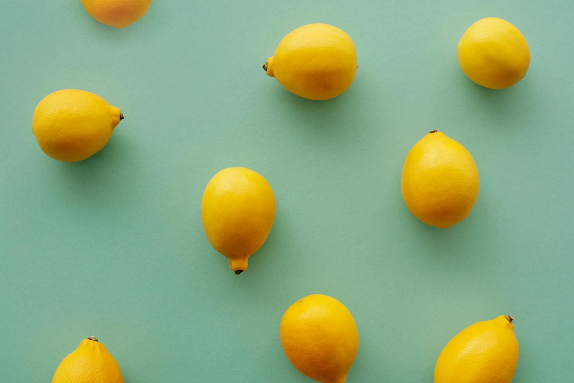 Bright yellow lemons arranged on a pastel background, representing fresh sensation and clarity