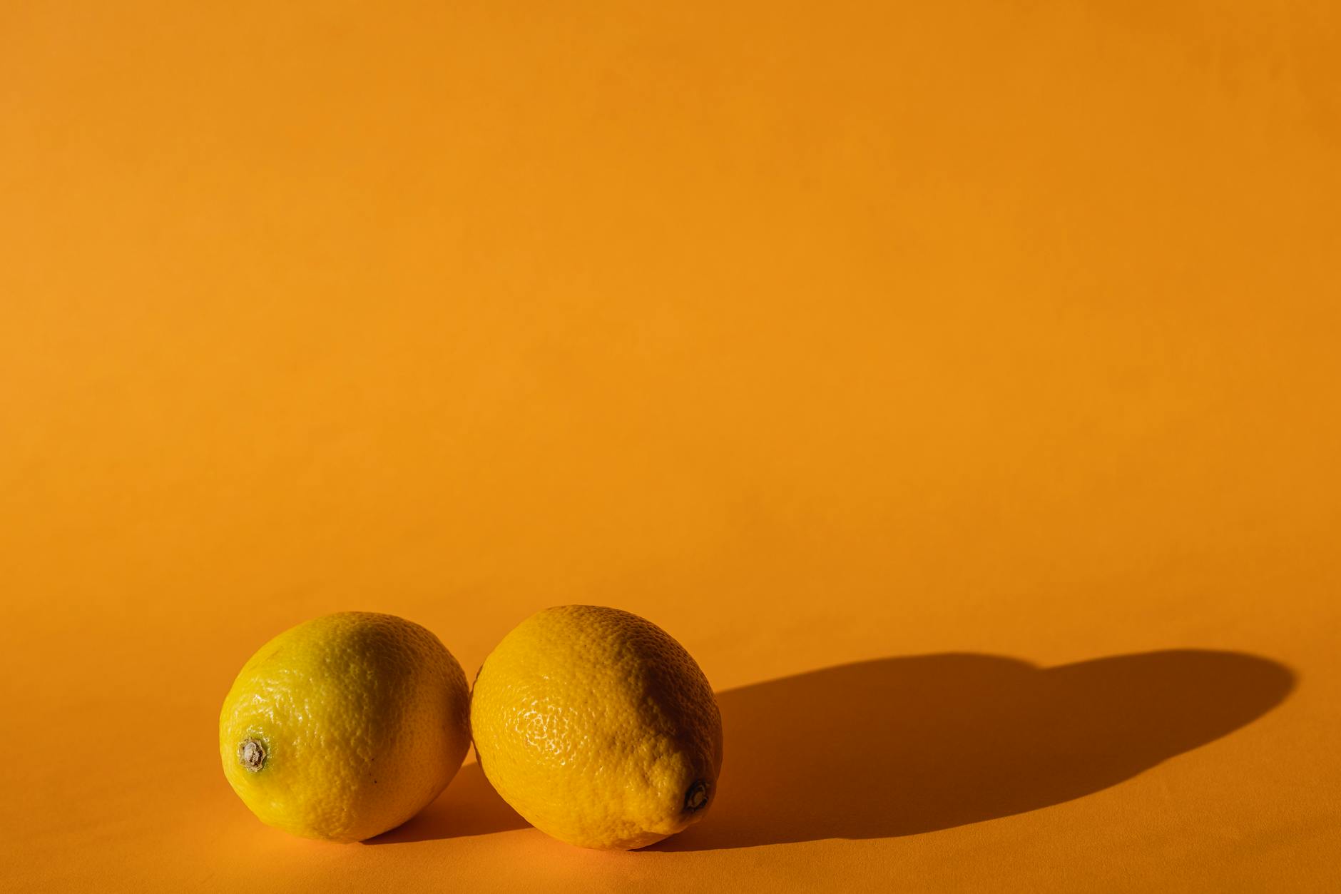 Bright lemons on a yellow background symbolizing fresh approaches to pelvic floor wellness